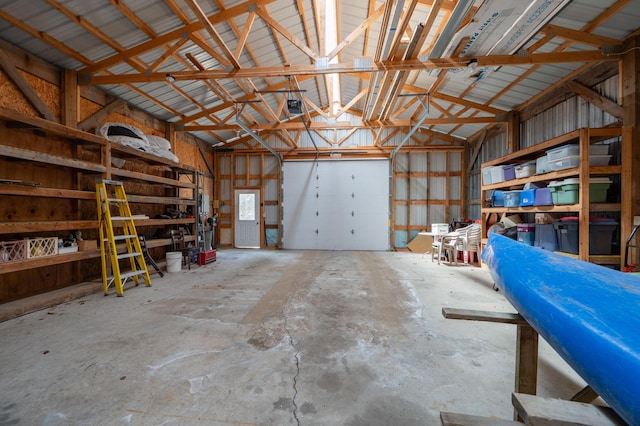 garage with metal wall and a garage door opener