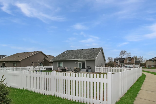 310 29th Ave SE, Saint Cloud, MN 56304 - back of house with a residential view, a shingled roof, and a patio area