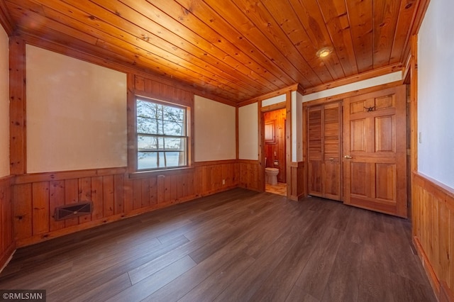 27042 Round Lake Rd, Bay Lake Twp, MN 56444 - empty room with visible vents, wainscoting, wood finished floors, wooden ceiling, and wooden walls