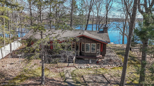 27042 Round Lake Rd, Bay Lake Twp, MN 56444 - rear view of property featuring a water view, a shingled roof, and a chimney
