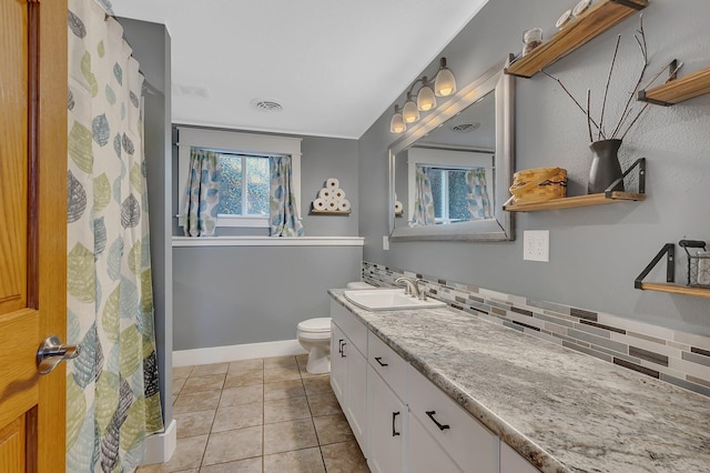 26063 County Road 2, Saint Joseph Twp, MN 56301 - full bath with toilet, tile patterned flooring, tasteful backsplash, vanity, and baseboards