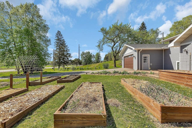 26063 County Road 2, Saint Joseph Twp, MN 56301 - view of green lawn with a vegetable garden, concrete driveway, and an attached garage