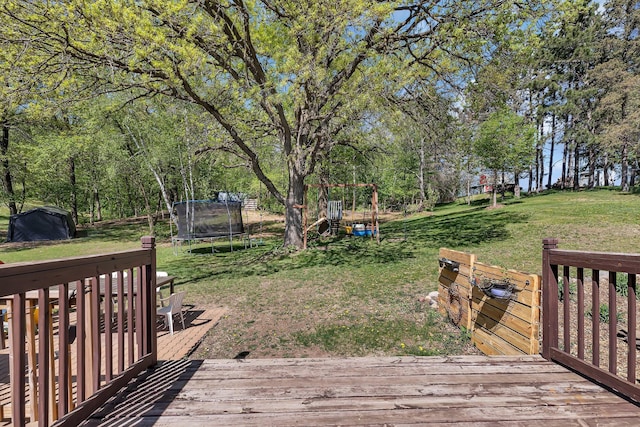 26063 County Road 2, Saint Joseph Twp, MN 56301 - wooden deck featuring a trampoline and a lawn