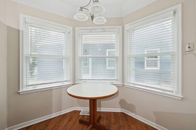 2613 Inglewood Ave S, Saint Louis Park, MN 55416 - dining area featuring a chandelier, dark wood-style flooring, and healthy amount of natural light