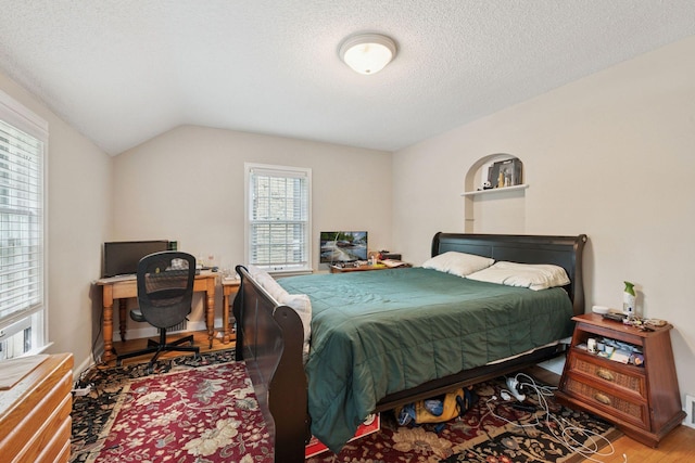 2613 Inglewood Ave S, Saint Louis Park, MN 55416 - bedroom featuring wood finished floors, a textured ceiling, and lofted ceiling