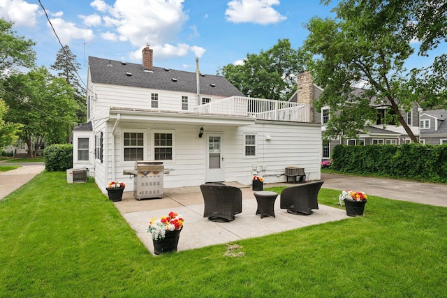 2613 Inglewood Ave S, Saint Louis Park, MN 55416 - rear view of property featuring a patio, a chimney, a yard, and a balcony