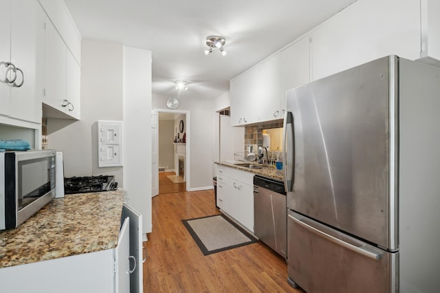 2613 Inglewood Ave S, Saint Louis Park, MN 55416 - kitchen featuring appliances with stainless steel finishes, light wood finished floors, white cabinetry, and light countertops