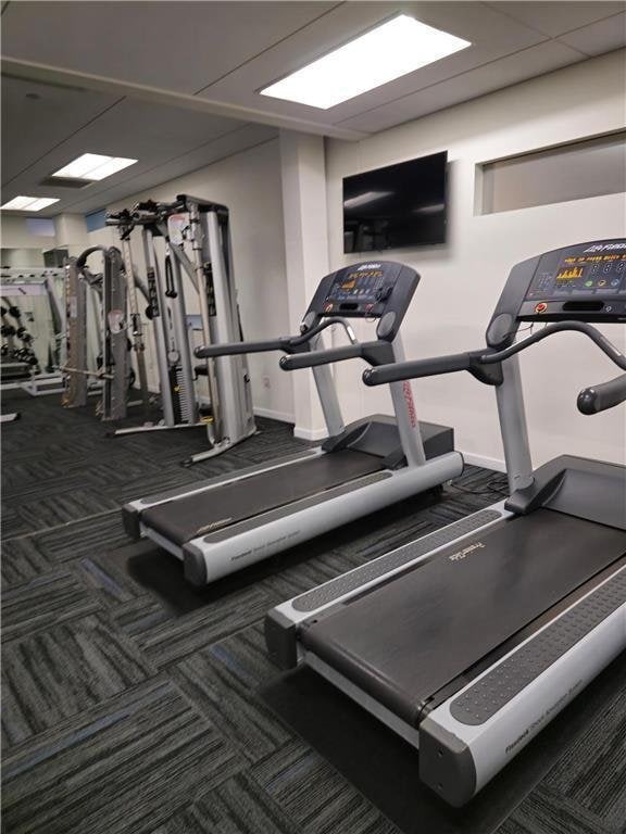 workout area with carpet floors and baseboards