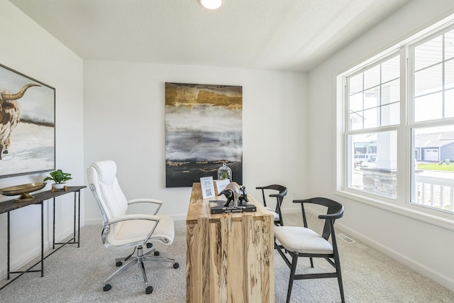 carpeted office featuring baseboards