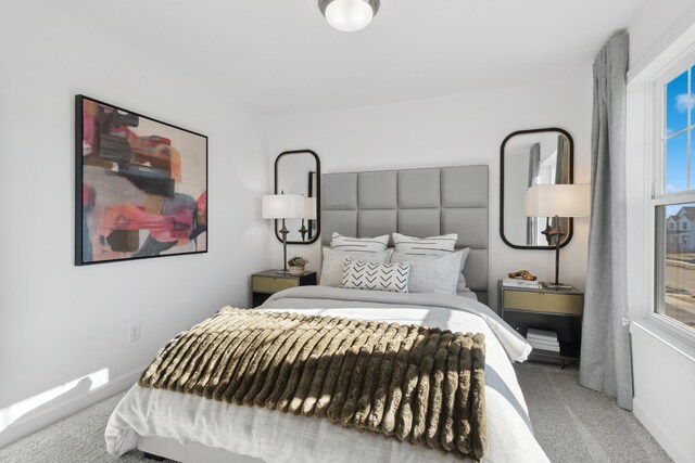 bedroom featuring baseboards, multiple windows, and carpet flooring