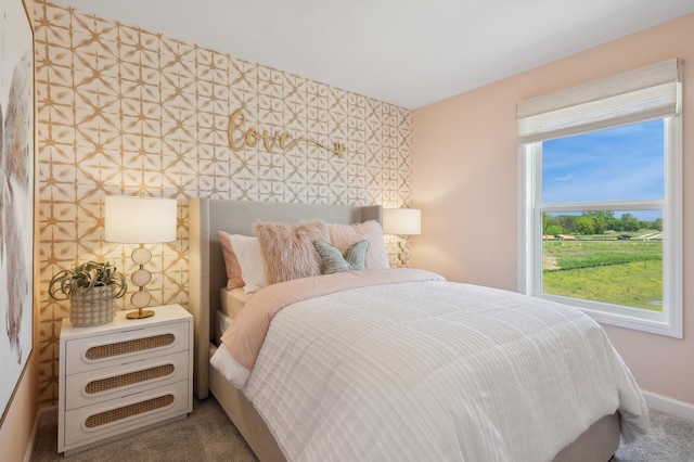 carpeted bedroom featuring baseboards