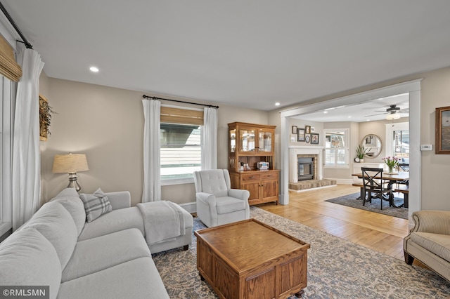 living area with plenty of natural light, a fireplace, recessed lighting, and wood finished floors