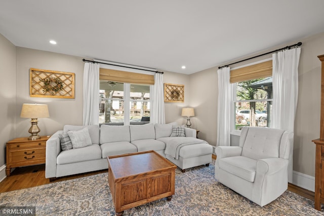 living area with baseboards, recessed lighting, and wood finished floors