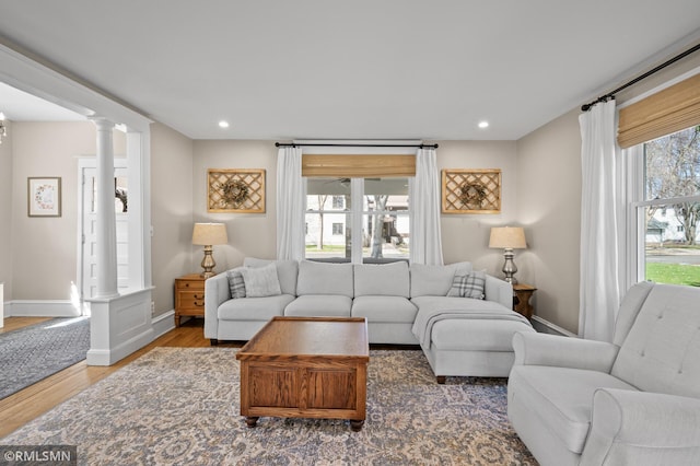 living room with ornate columns, baseboards, recessed lighting, and wood finished floors