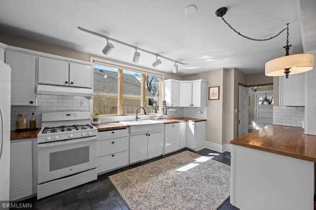 kitchen with a sink, white appliances, butcher block countertops, backsplash, and under cabinet range hood