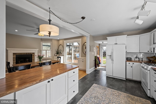 kitchen with a ceiling fan, white appliances, butcher block countertops, and open floor plan