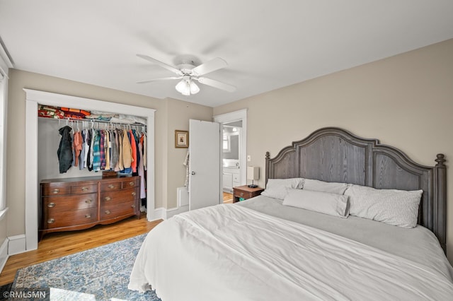 bedroom featuring baseboards, a ceiling fan, a closet, and wood finished floors