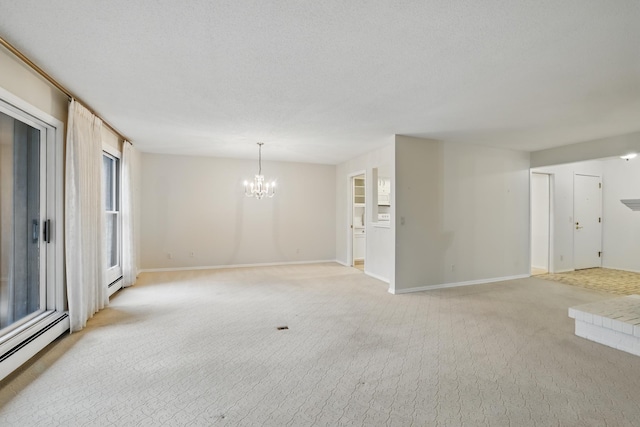 unfurnished room with light colored carpet, baseboards, a baseboard heating unit, and a chandelier