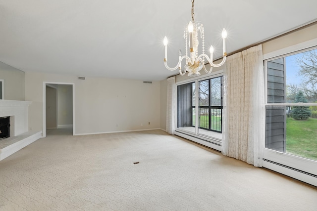 unfurnished living room with visible vents, baseboards, baseboard heating, a fireplace with raised hearth, and a notable chandelier