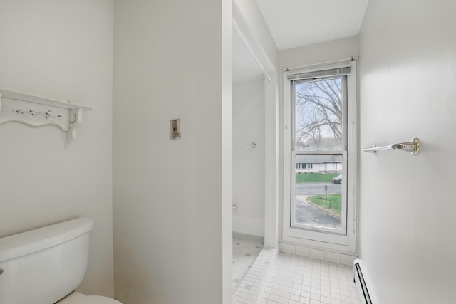 full bathroom featuring toilet, baseboard heating, tile patterned floors, a baseboard radiator, and a tile shower