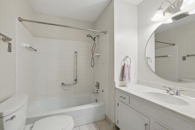 bathroom featuring tile patterned flooring, tub / shower combination, toilet, and vanity
