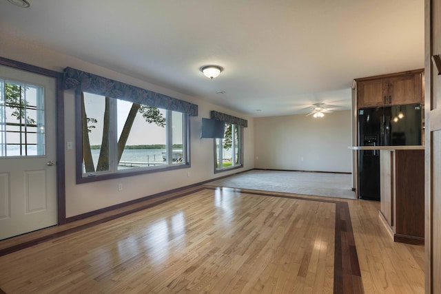 22694 Coney Island Dr, Clitherall, MN 56524 - unfurnished living room with light wood-style floors, baseboards, and ceiling fan