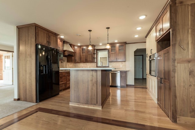 22694 Coney Island Dr, Clitherall, MN 56524 - kitchen featuring appliances with stainless steel finishes, custom range hood, light wood-style floors, a kitchen island, and glass insert cabinets