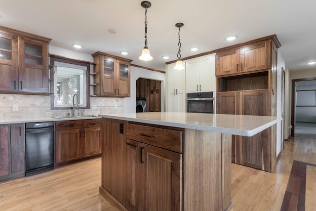 22694 Coney Island Dr, Clitherall, MN 56524 - kitchen featuring a sink, oven, a center island, light wood finished floors, and decorative backsplash