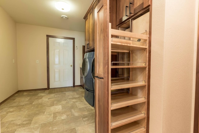 22694 Coney Island Dr, Clitherall, MN 56524 - laundry area with cabinet space, stone finish floors, and baseboards