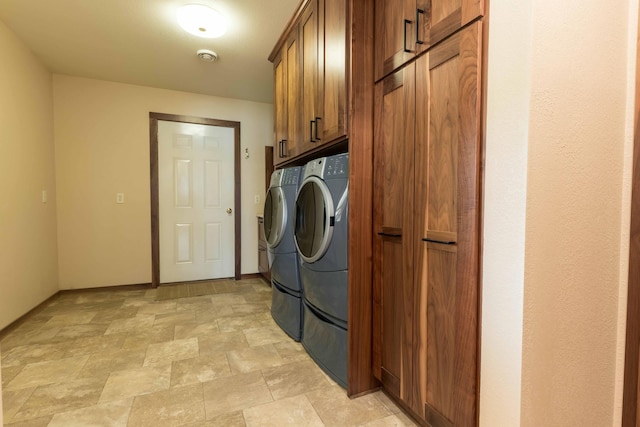 22694 Coney Island Dr, Clitherall, MN 56524 - washroom with washer and clothes dryer, cabinet space, stone finish flooring, and baseboards