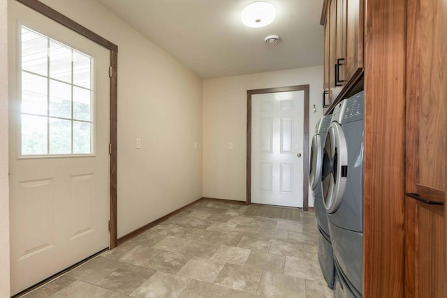 22694 Coney Island Dr, Clitherall, MN 56524 - washroom featuring cabinet space, separate washer and dryer, baseboards, and stone finish flooring