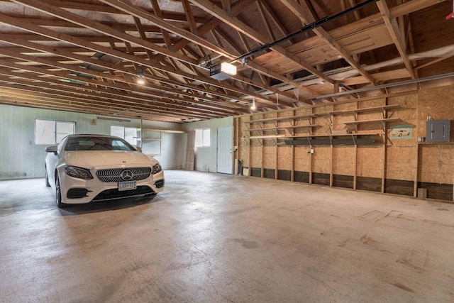 22694 Coney Island Dr, Clitherall, MN 56524 - garage featuring electric panel and a garage door opener