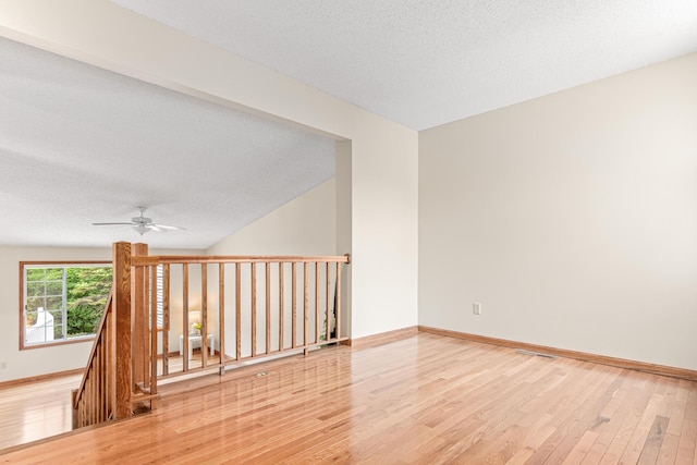5676 Donegal Dr, Shoreview, MN 55126 - empty room with wood finished floors, ceiling fan, a textured ceiling, and baseboards