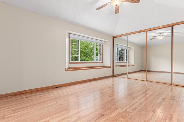 5676 Donegal Dr, Shoreview, MN 55126 - unfurnished bedroom featuring wood finished floors, vaulted ceiling, baseboards, ceiling fan, and a closet