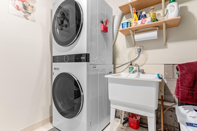 5676 Donegal Dr, Shoreview, MN 55126 - laundry room with stacked washer and clothes dryer and baseboards