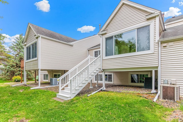 5676 Donegal Dr, Shoreview, MN 55126 - back of house with central AC unit, a yard, stairway, and roof with shingles