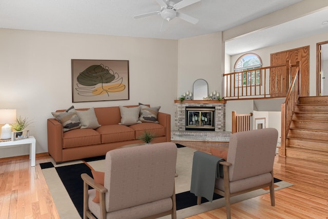 5676 Donegal Dr, Shoreview, MN 55126 - living room with a ceiling fan, wood finished floors, a brick fireplace, and stairs