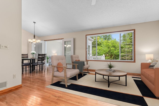 5676 Donegal Dr, Shoreview, MN 55126 - living area with wood-type flooring, a chandelier, baseboards, and a textured ceiling