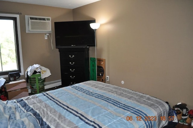 bedroom with baseboard heating and a wall mounted air conditioner