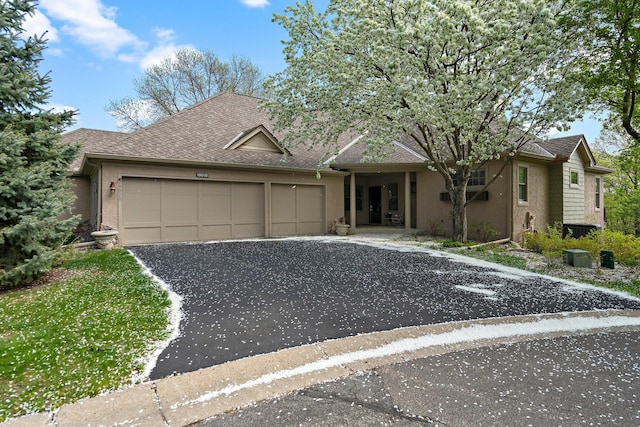 19010 Ashcroft Cir, Minnetonka, MN 55345 - ranch-style home with driveway, a garage, a shingled roof, and stucco siding