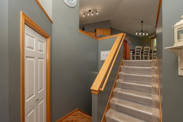 822 Emerson Ave N, Montrose, MN 55363 - staircase featuring vaulted ceiling, a chandelier, and rail lighting