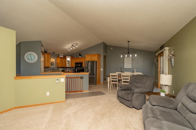 822 Emerson Ave N, Montrose, MN 55363 - living area featuring light colored carpet, lofted ceiling, a chandelier, and a textured ceiling