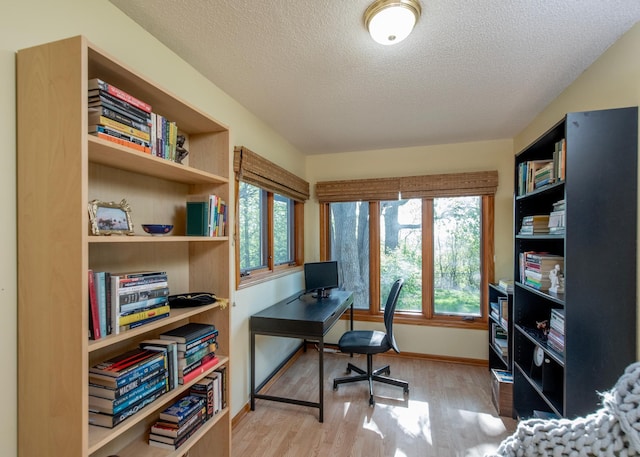 office with wood finished floors, a textured ceiling, and baseboards