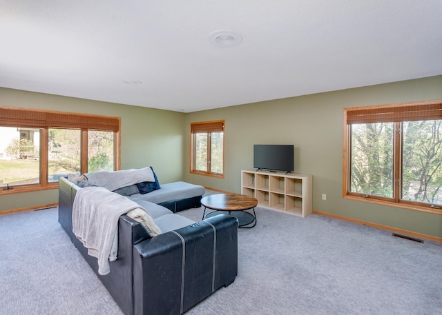 carpeted living room with baseboards