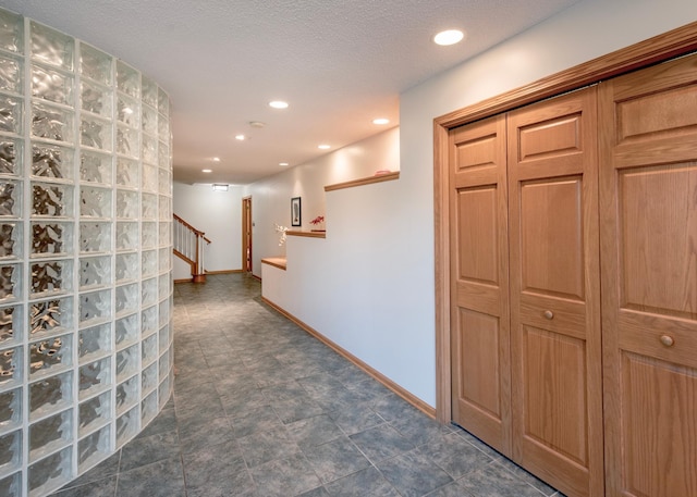 corridor featuring stairway, baseboards, and recessed lighting