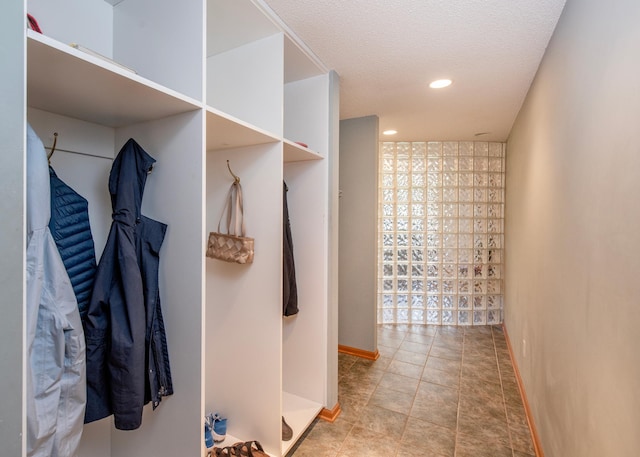 corridor with baseboards and recessed lighting