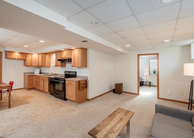 kitchen with black appliances, a drop ceiling, under cabinet range hood, baseboards, and light countertops