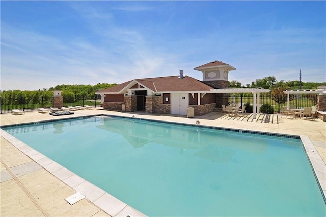 community pool with fence and a patio area