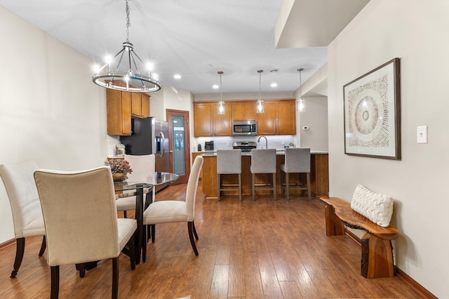 dining room featuring baseboards, recessed lighting, and dark wood-style floors