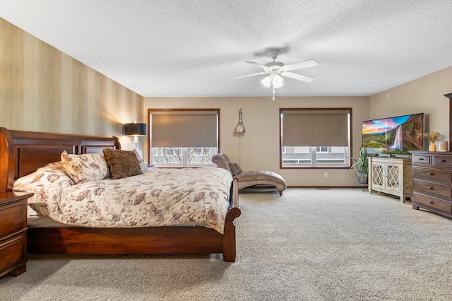 carpeted bedroom with a ceiling fan and a textured ceiling